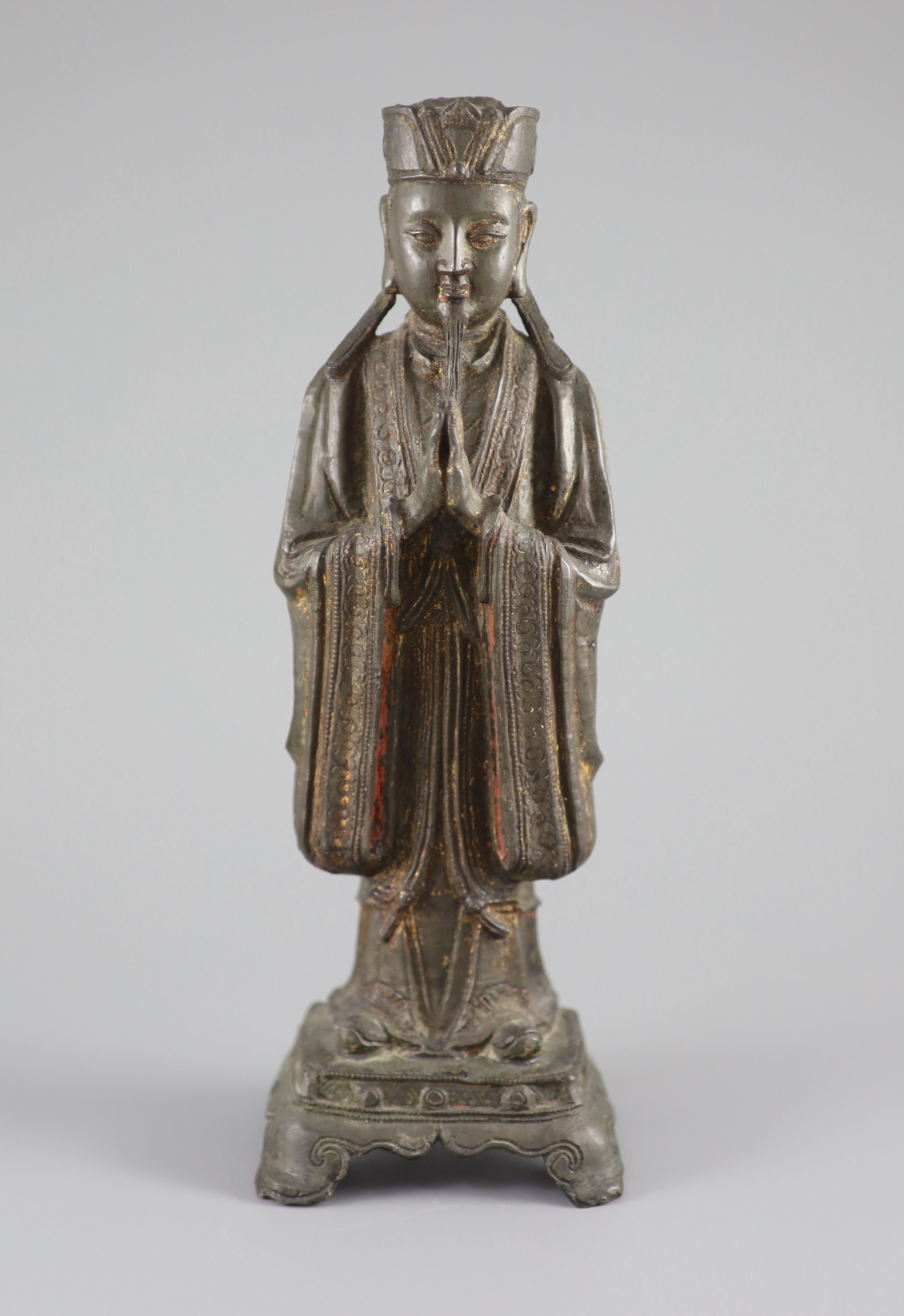 A Chinese bronze standing figure of an immortal, late Ming, 17th century, 31.3 cm high